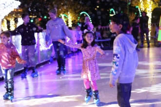 Children skate at the rink in the Downtown Cary Park